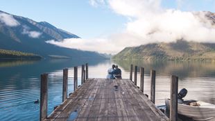 large dock on water with landscape in background