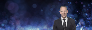 Andrew Nathanson headshot on sparkle background