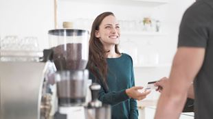 young woman receiving credit card in store