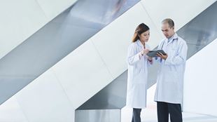two healthcare professionals looking at chart
