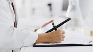  Scientist with tablet, science and writing notes for medical research and digital test results, study and checklist. Biotechnology, scientific innovation and online data with person hand in lab