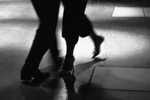 Action shot of the feet of two people dancing tango