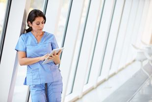 healthcare professional looking at tablet