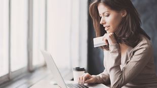woman at laptop with her credit card