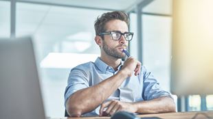 man working at computer at a desk