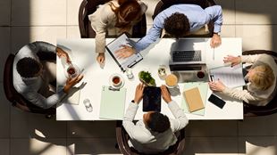 Above view of diverse colleagues having a discussion on a meeting in the office