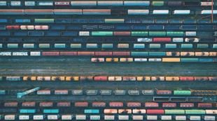 looking down from a distance at railroad transport cars