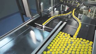 caps being put on in automated machine