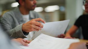  Close-Up of Business Professionals Reviewing Documents