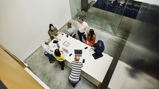  Wide high angle shot businesswoman leading project meeting in office