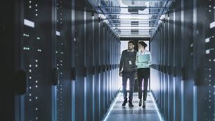 two people walking through data centre