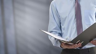 closeup of man looking at binder