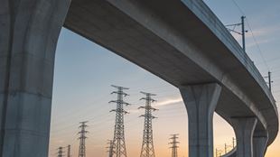 overpass highway with electrical towers in background