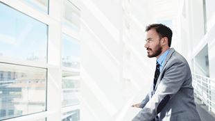 man looking out of building