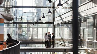 Business colleagues discussing at atrium in office