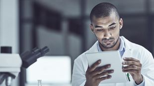 Scientist reading notes in lab