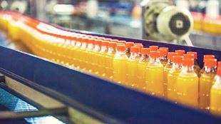 orange juice bottles in factory 