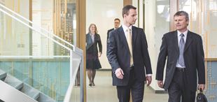 two business people coming around stairs