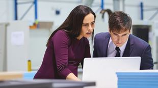 woman and man looking at computer 